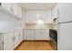 Kitchen with white cabinets, stainless steel appliances, and wood flooring at 3460 S Poplar St # 307, Denver, CO 80224