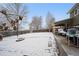 Large backyard with patio, fire pit, and snow-covered lawn at 6310 W 110Th Pl, Westminster, CO 80020