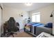 Bright bedroom with a double bed, desk, and window at 20000 Mitchell Pl # 71, Denver, CO 80249