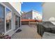 Back deck with built-in grill and view of neighboring houses at 20000 Mitchell Pl # 71, Denver, CO 80249
