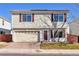 Two-story house with attached garage and brick driveway at 20000 Mitchell Pl # 71, Denver, CO 80249