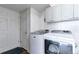 Laundry room with washer, dryer, and cabinets at 20000 Mitchell Pl # 71, Denver, CO 80249