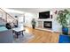 Open living area with hardwood floors, fireplace, and stairs at 20000 Mitchell Pl # 71, Denver, CO 80249