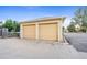 Two-car garage with paved driveway and additional parking space at 1432 Xanthia St, Denver, CO 80220