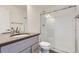 Modern bathroom with gray vanity, shower, and toilet at 10231 E 62Nd Pl, Denver, CO 80238