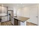 Modern kitchen with gray cabinets, island, and stainless steel appliances at 10231 E 62Nd Pl, Denver, CO 80238