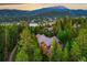 Mountaintop home surrounded by trees with distant town view at 120 Windwood Cir, Breckenridge, CO 80424
