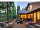 Back deck with seating area, surrounded by trees at 120 Windwood Cir, Breckenridge, CO 80424