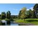 Serene pond with fountain, landscaping, and building view at 13500 E Cornell Ave # 302, Aurora, CO 80014
