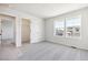 Bright bedroom with a large closet and two windows at 8389 Vona Ln, Littleton, CO 80125