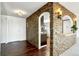 Entryway with a stone accent wall and dark hardwood floors at 14152 E Linvale Pl # 605, Aurora, CO 80014