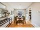 Bright dining area with hardwood floors and a glass-top dining table at 6513 Teller St, Arvada, CO 80003