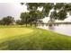 Green golf course landscape with pond and trees at 2896 W Riverwalk Cir # A102, Littleton, CO 80123