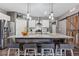 Modern kitchen featuring a large island, stainless steel appliances, and granite countertops at 8938 Ferncrest St, Longmont, CO 80504