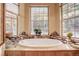 Relaxing bathroom with a large oval tub and stone accents at 7948 S Turkey Creek Rd, Morrison, CO 80465