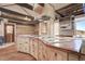 Rustic kitchen with exposed beams, custom cabinetry, and copper countertops at 7948 S Turkey Creek Rd, Morrison, CO 80465