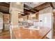 Copper countertop island kitchen with exposed beams and stainless steel appliances at 7948 S Turkey Creek Rd, Morrison, CO 80465