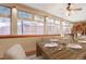Bright dining room with large windows and a wooden table set for a meal at 7948 S Turkey Creek Rd, Morrison, CO 80465