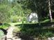 Landscaped yard with shed and stone pathway at 7948 S Turkey Creek Rd, Morrison, CO 80465