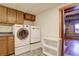 Laundry room with washer, dryer, and wooden cabinets at 7948 S Turkey Creek Rd, Morrison, CO 80465