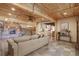 Open concept living area with exposed beams and stone fireplace at 7948 S Turkey Creek Rd, Morrison, CO 80465