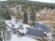 Aerial view of house and surrounding area showcasing the property's expansive landscape at 7948 S Turkey Creek Rd, Morrison, CO 80465