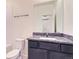 Clean bathroom with granite countertop, dark vanity, and updated fixtures at 7203 Arkansas St, Frederick, CO 80530