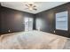 Spacious bedroom with dark-colored walls, carpeting, and a sliding glass door at 7203 Arkansas St, Frederick, CO 80530