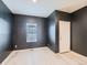 Simple bedroom with dark walls, light flooring and a window at 7203 Arkansas St, Frederick, CO 80530