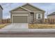 One-story house with a green exterior, attached garage, and a small front yard at 7203 Arkansas St, Frederick, CO 80530