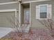 Front entrance of the house with steps, shrubs, and light fixtures at 7203 Arkansas St, Frederick, CO 80530