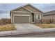 House exterior with attached two-car garage and landscaping at 7203 Arkansas St, Frederick, CO 80530