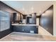 Modern kitchen with dark cabinets, granite countertops, and stainless steel appliances at 7203 Arkansas St, Frederick, CO 80530