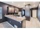 Modern kitchen with dark cabinets, granite countertops, and stainless steel appliances at 7203 Arkansas St, Frederick, CO 80530