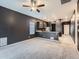 Open living room and kitchen area with dark walls and carpeted floors at 7203 Arkansas St, Frederick, CO 80530