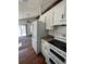 Kitchen with white appliances and wood flooring at 18064 E Ford Pl, Aurora, CO 80017