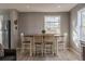 Farmhouse style dining area with a wooden table and four chairs at 5402 E 60Th Way, Commerce City, CO 80022