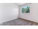 Well-lit bedroom with grey carpet and window overlooking trees at 1246 S Zeno Cir # E, Aurora, CO 80017