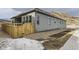 Gray house exterior with wooden fence and landscaping at 1871 Grayside Cir, Castle Rock, CO 80109
