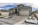 Modern home's exterior with a two-car garage and stone accents at 1871 Grayside Cir, Castle Rock, CO 80109