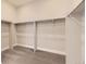 Large walk-in closet with double hanging rods and neutral carpeting at 1871 Grayside Cir, Castle Rock, CO 80109