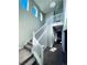 Bright entryway with a staircase featuring a white railing and gray carpeting at 19085 E 66Th Ave, Denver, CO 80249
