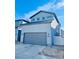 Two-story home with gray siding and a two-car garage at 19085 E 66Th Ave, Denver, CO 80249