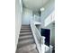 Open staircase with a light fixture and view of the entryway at 19085 E 66Th Ave, Denver, CO 80249