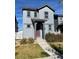 Two-story house with gray siding, red door, and landscaped front yard at 19085 E 66Th Ave, Denver, CO 80249