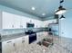 Modern kitchen with white cabinets and granite countertops at 19085 E 66Th Ave, Denver, CO 80249