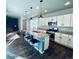 Bright kitchen, granite island, stainless steel appliances, open to Gathering room at 19085 E 66Th Ave, Denver, CO 80249