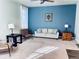 Living room with blue accent wall and comfortable seating at 19085 E 66Th Ave, Denver, CO 80249