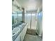 Bathroom with granite countertops, double sinks, and a shower at 19085 E 66Th Ave, Denver, CO 80249
