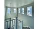 Open staircase with a light fixture and multiple windows at 19085 E 66Th Ave, Denver, CO 80249
